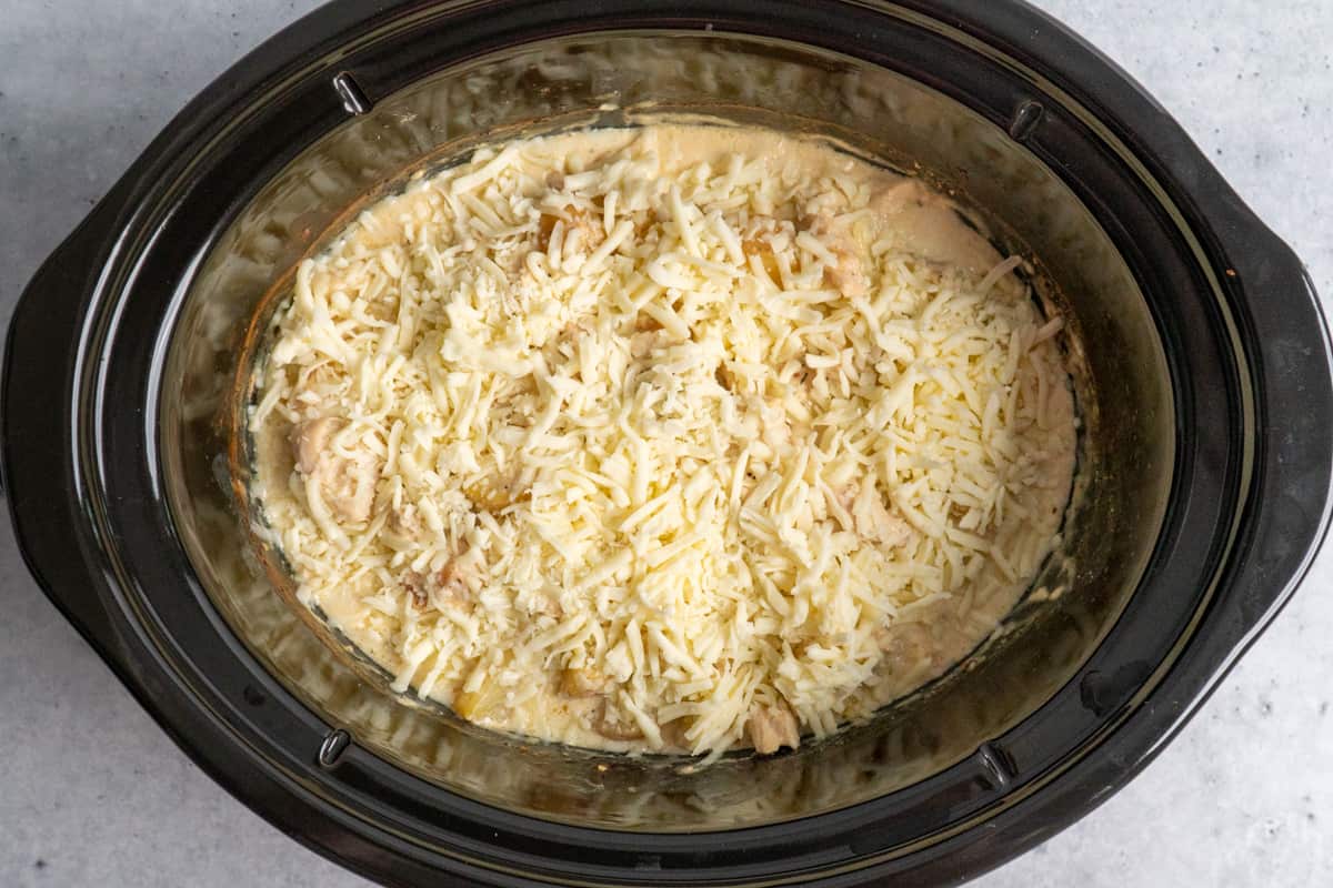 Recipe topped with shredded mozzarella cheese and ready to be melted.