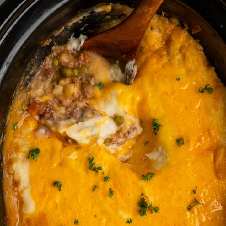 Overhead look at crock pot shepherds pie with a wooden spoon in it.