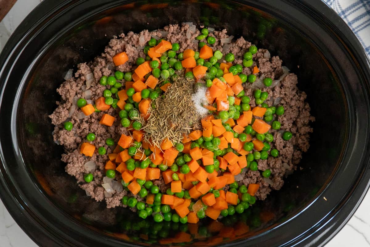 Spices and veggies on cooked ground beef for the shepherds pie filling.