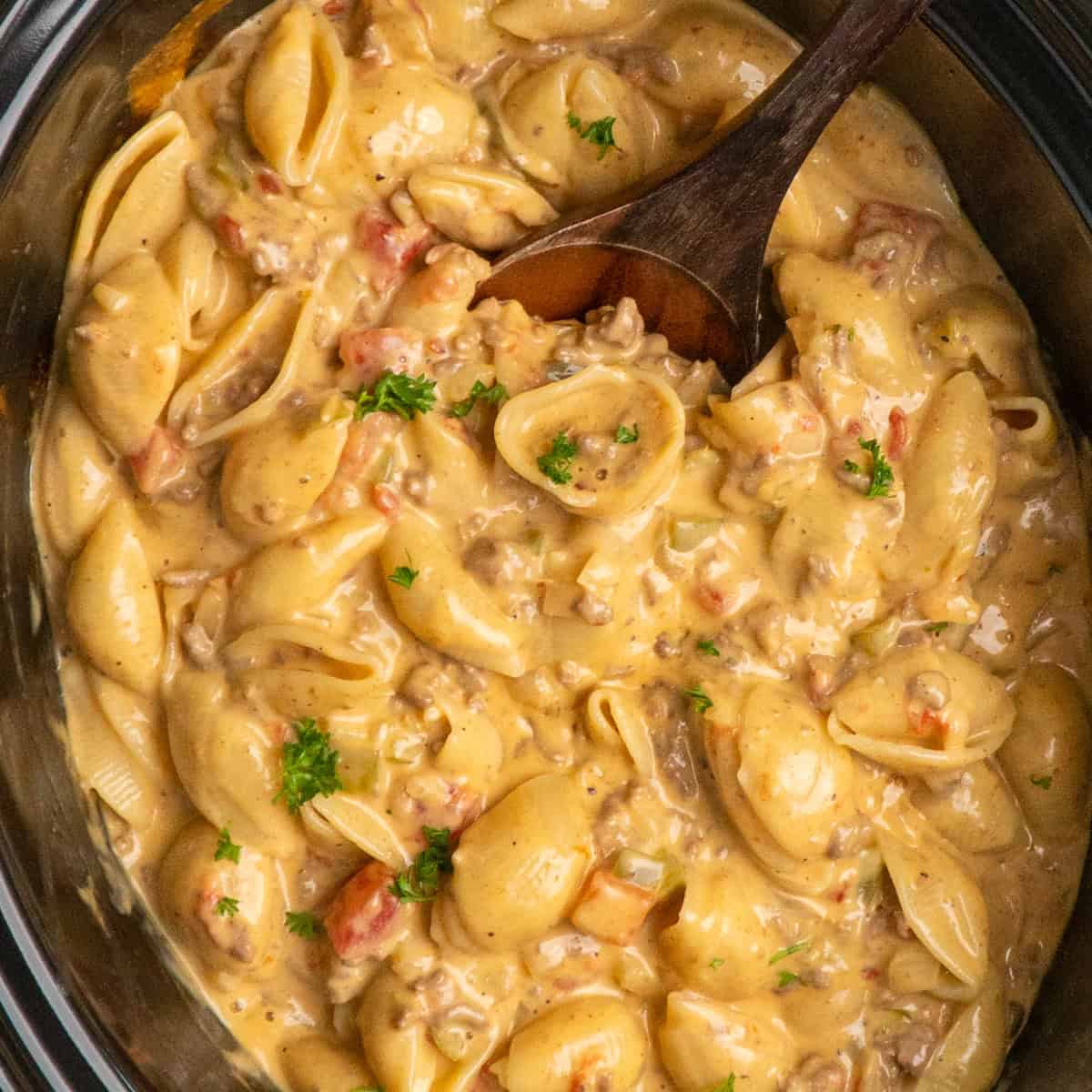 Crock Pot Rotel pasta with a wooden spoon.