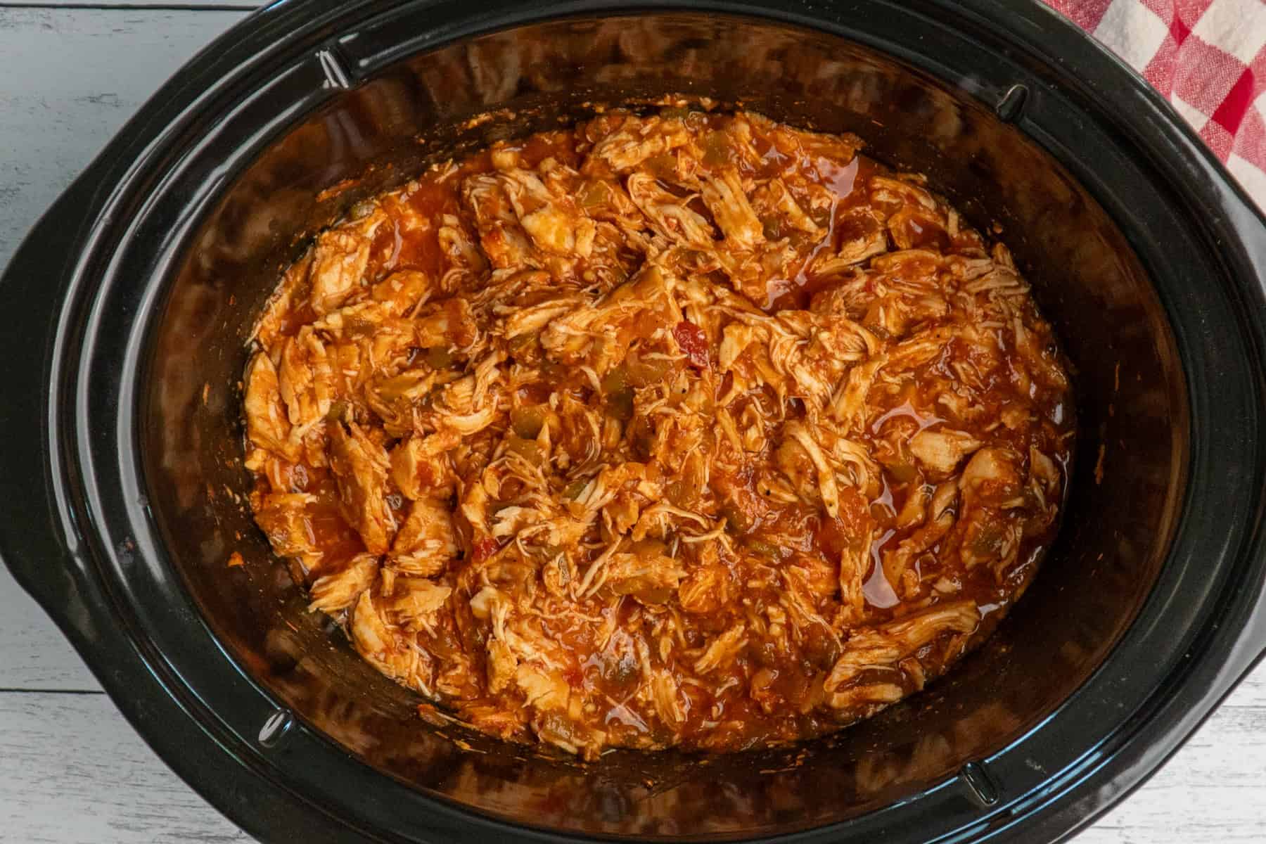 Overhead look at shredded salsa chicken in a crock pot.