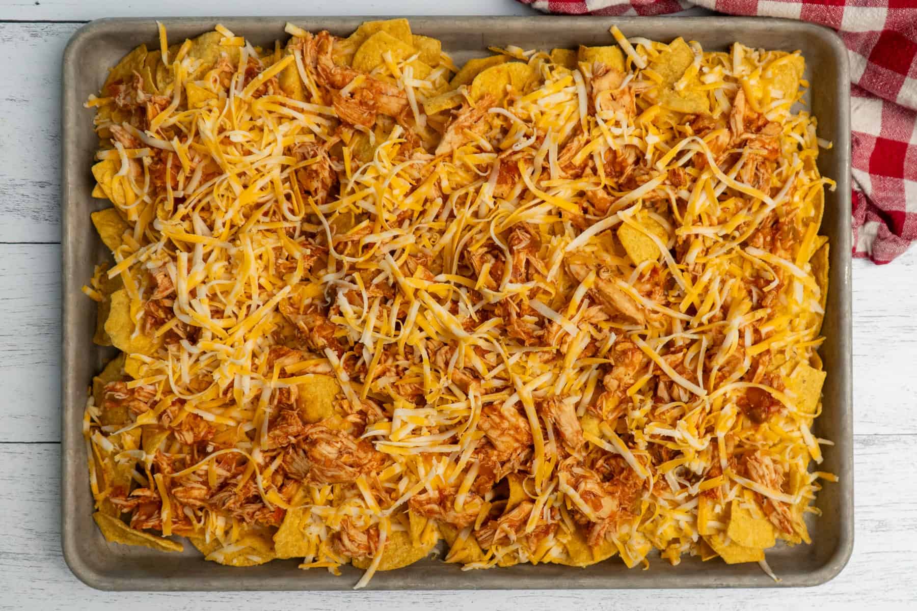 Tortilla chips covered in shredded chicken and cheese.