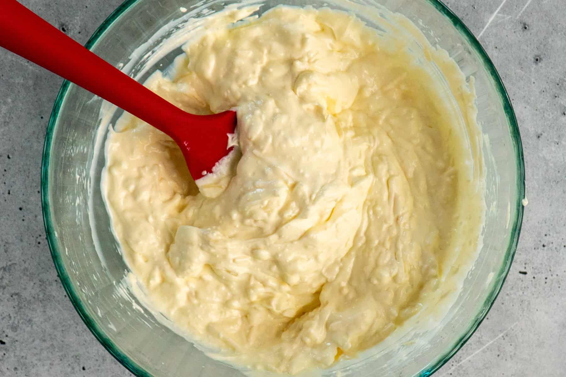 Wet ingredients mixed together in a clear bowl.