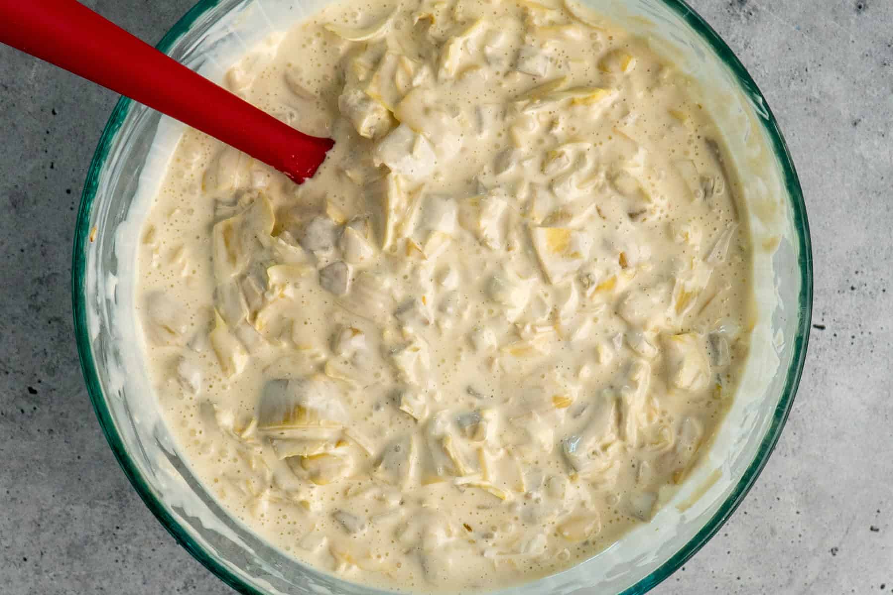 Artichokes, onion, and green chilies mixed into wet ingredients.