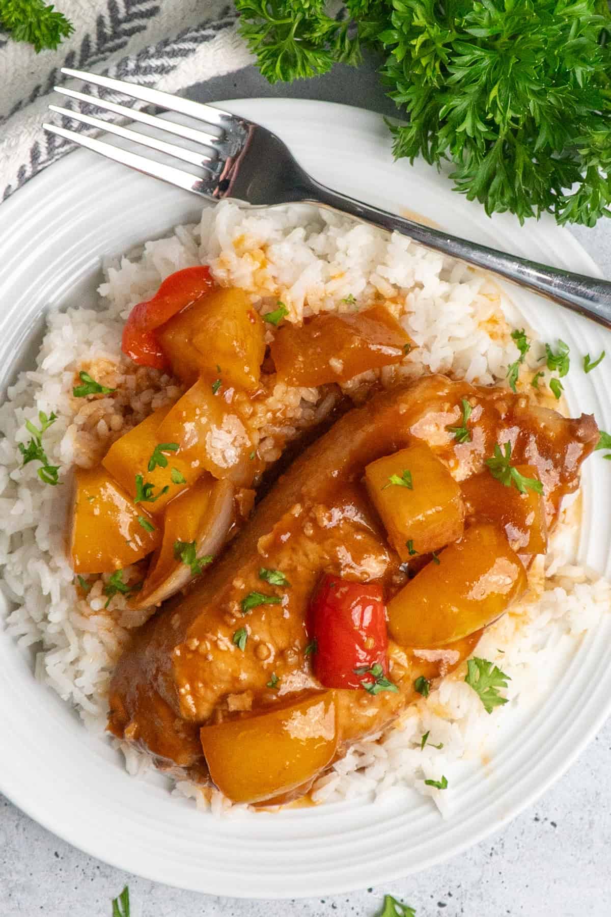 Hawaiian pork chops on a bed of rice.