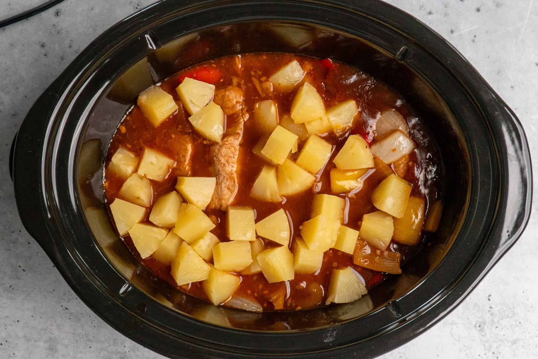 Pineapple chunks on top of the cooked Hawaiian pork chops.