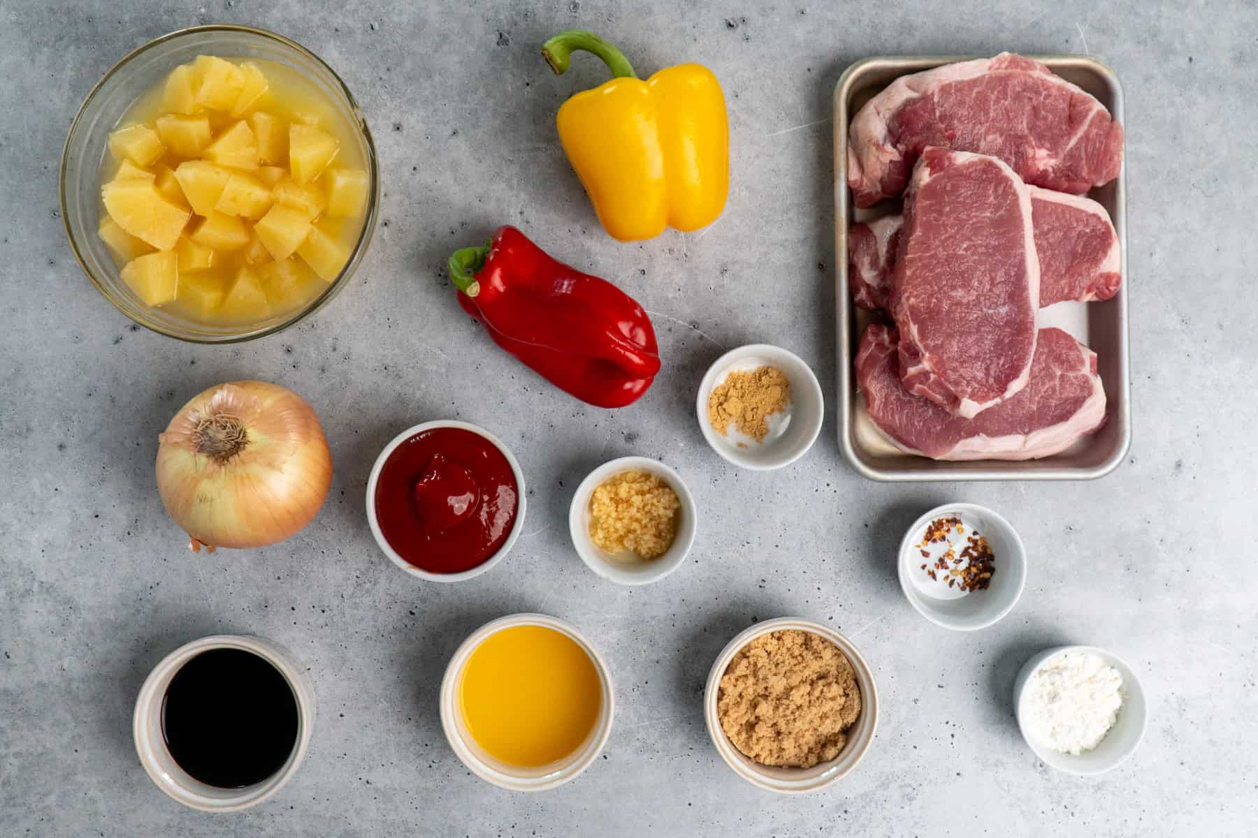 Ingredients to make slow cooker Hawaiian pork chops on a counter ready to be prepared.