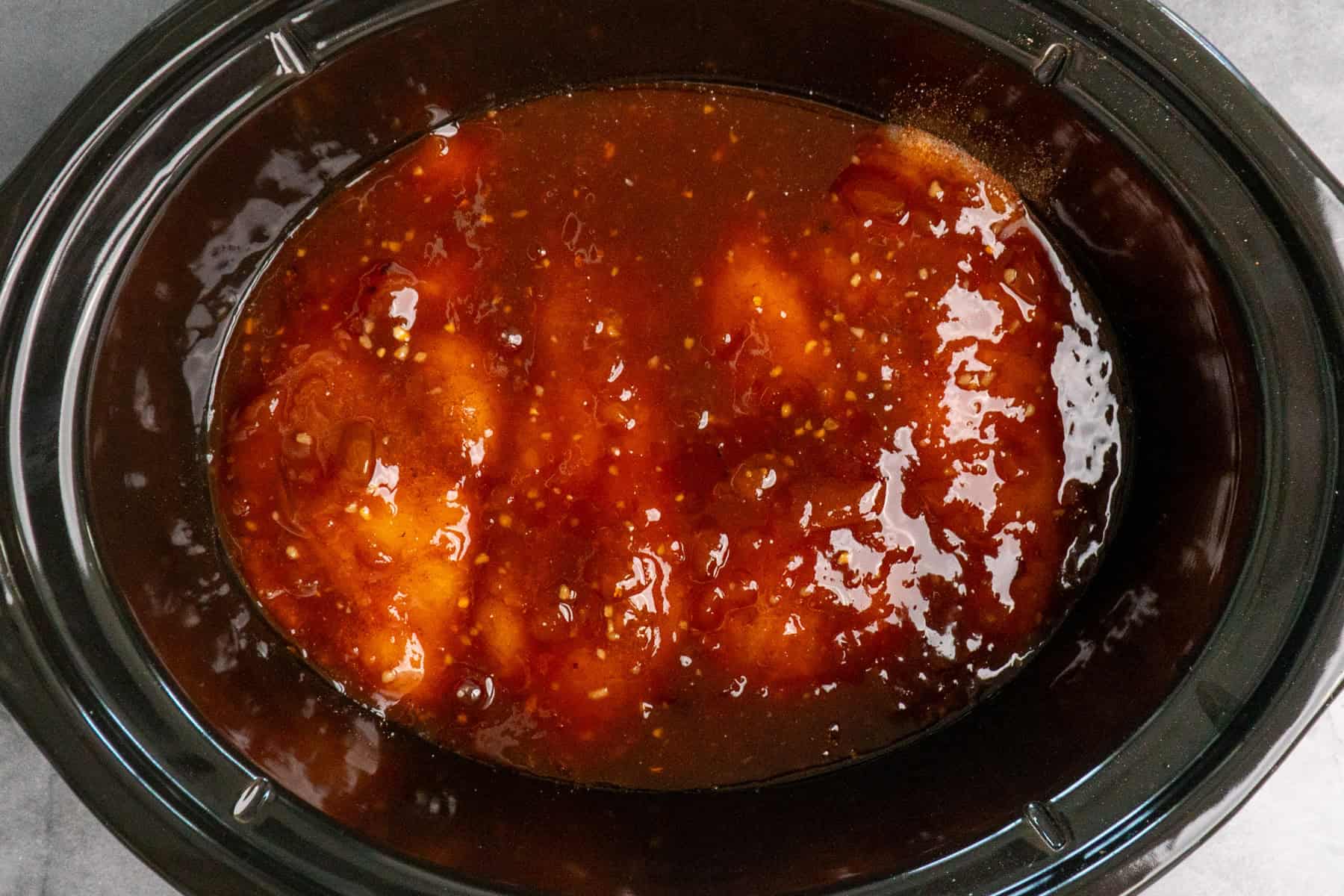 Chicken breasts in apricot sauce ready to be cooked.