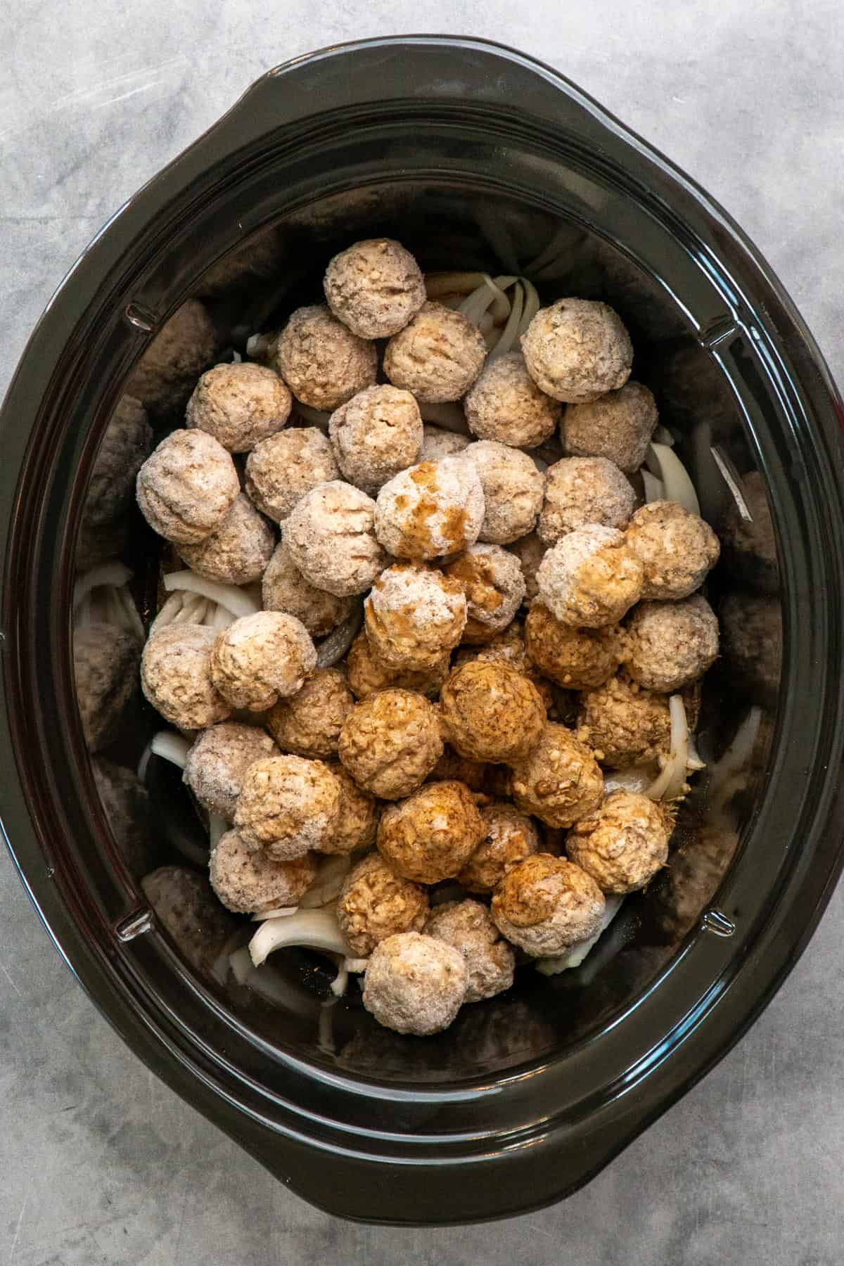 French onion meatballs ready to be cooked in a Crock Pot.