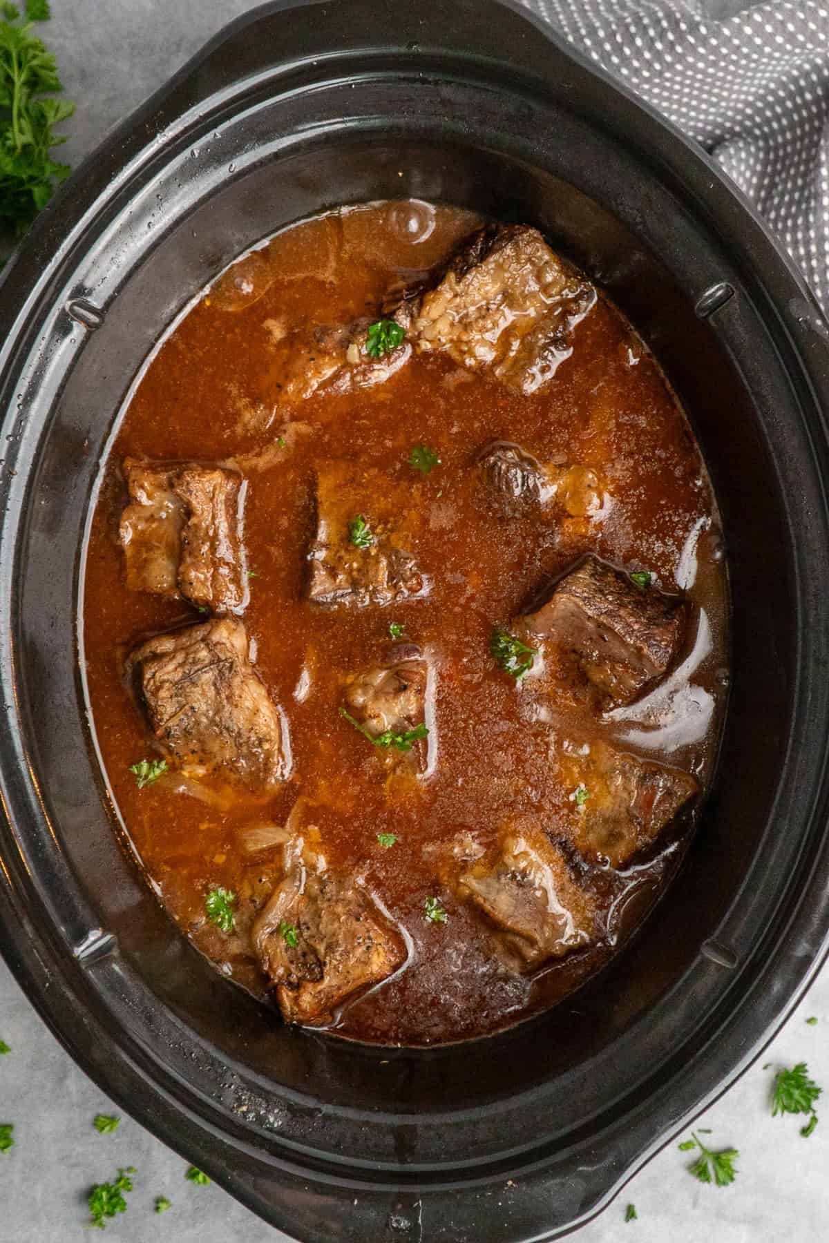 Cooked short ribs in a slow cooker.