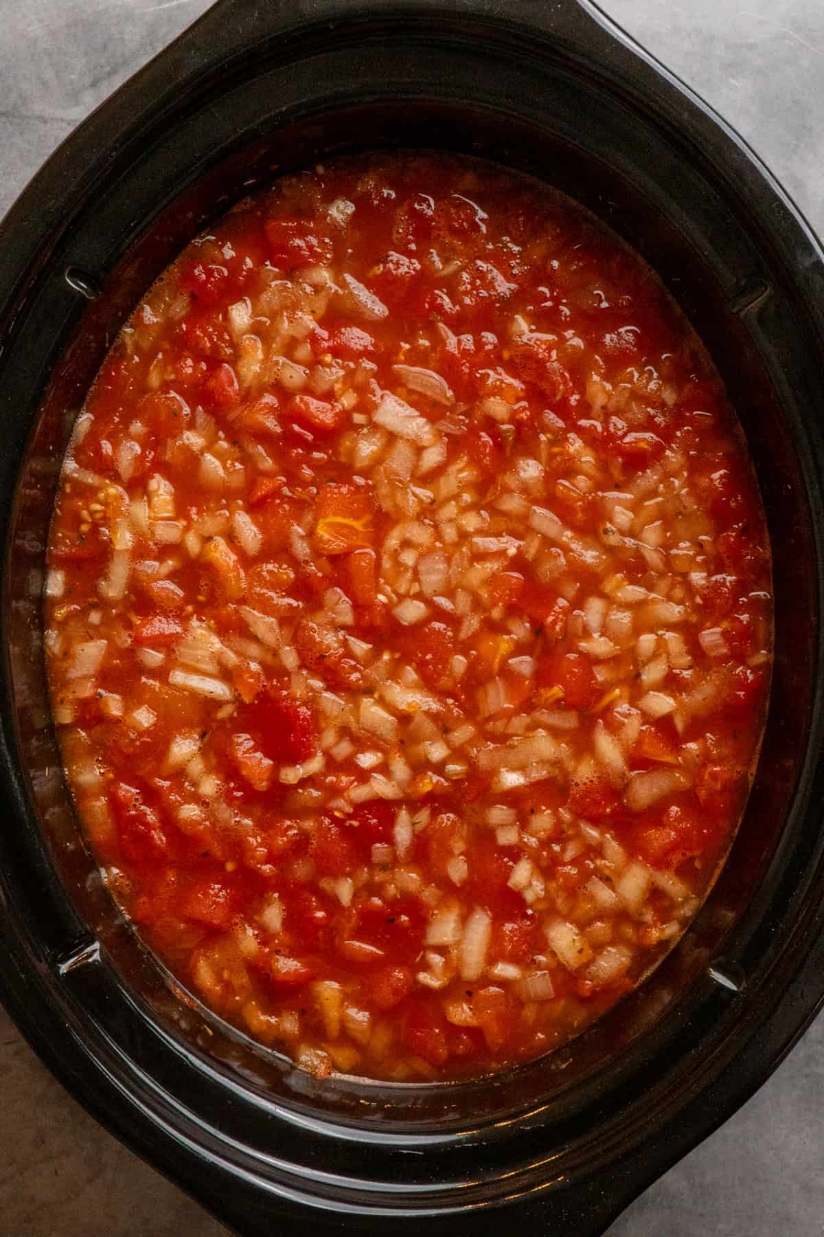 Cooked soup broth in a crock pot.