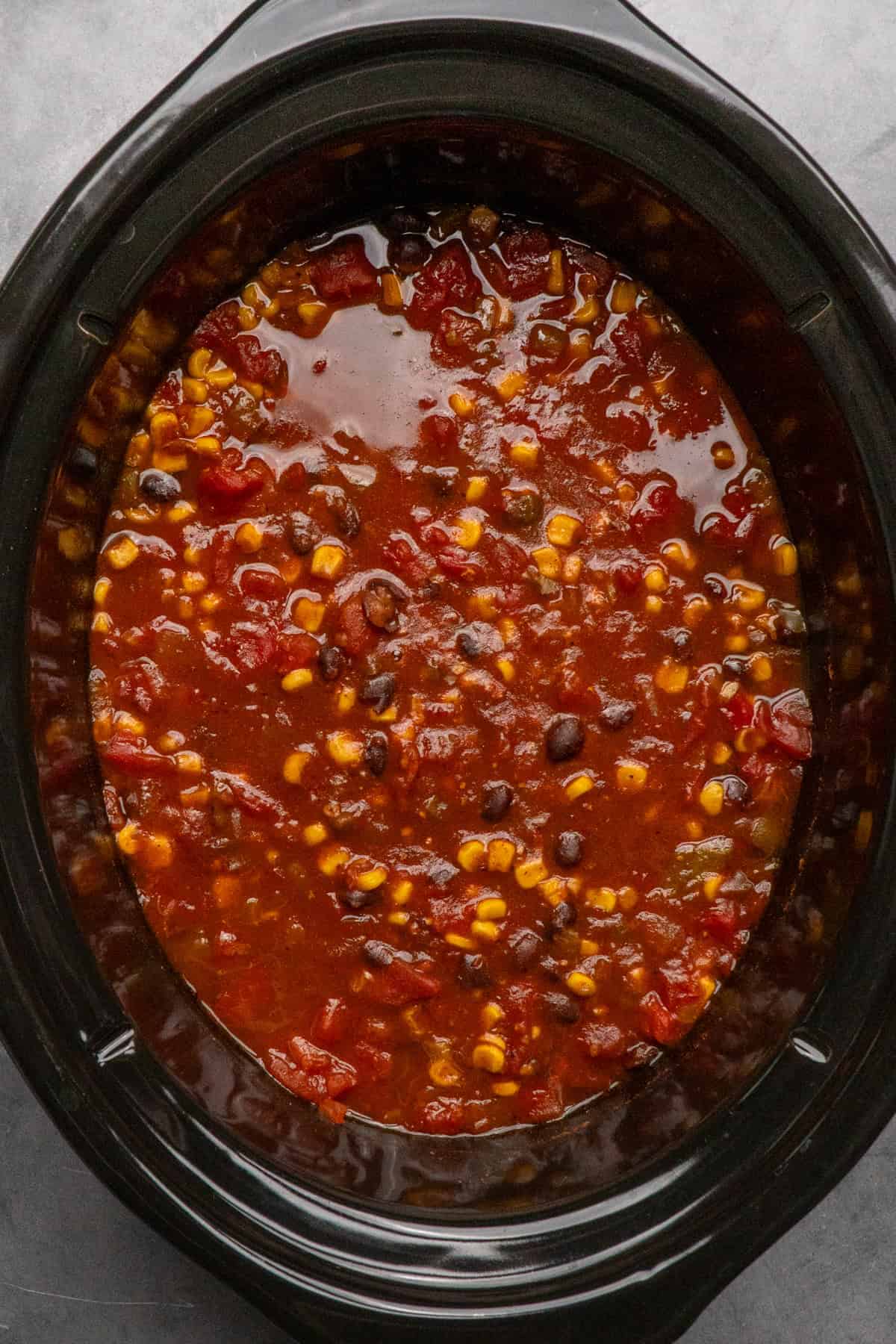 Cooked sauce and chicken in a slow cooker.