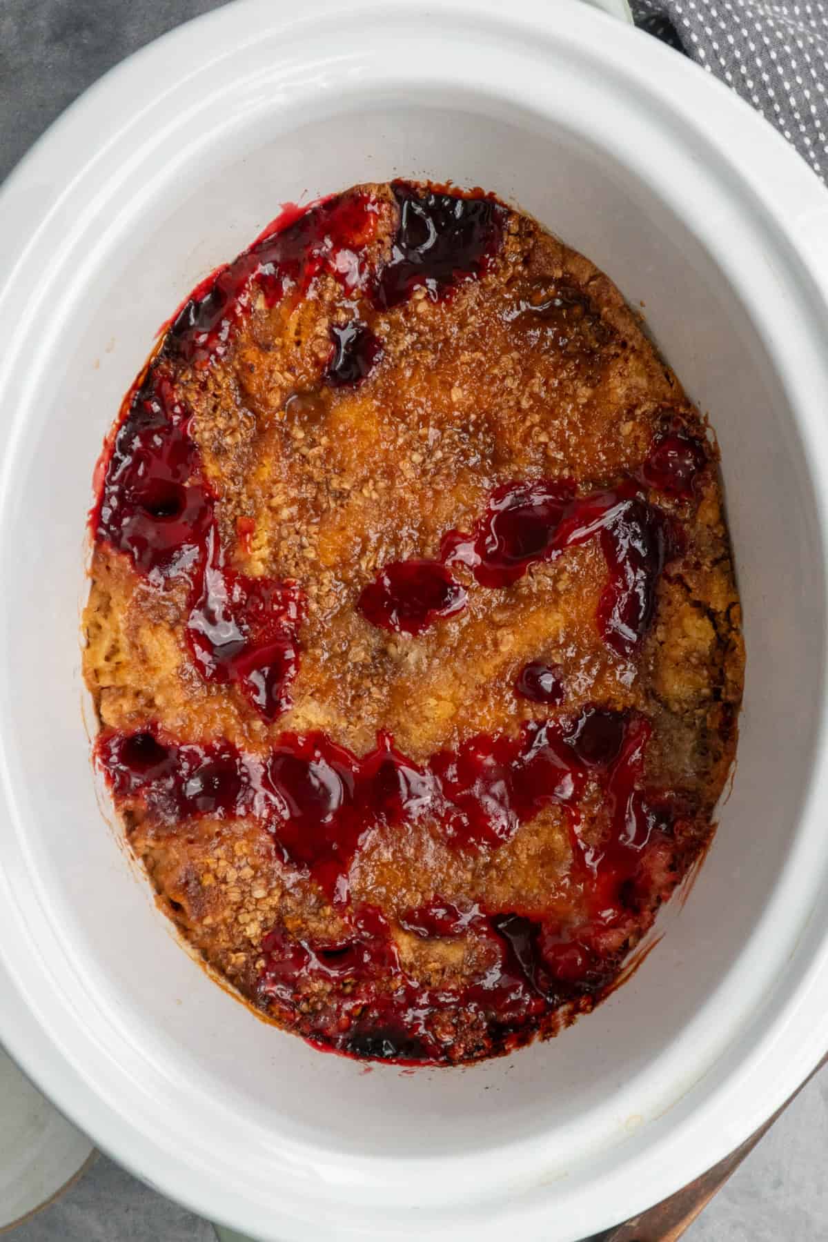 Cooked crock pot cherry cobbler ready to be served.