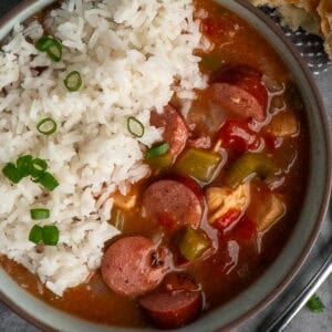 Slow cooker gumbo in a bowl with rice.