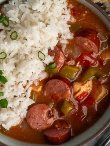 Slow cooker gumbo in a bowl with rice.