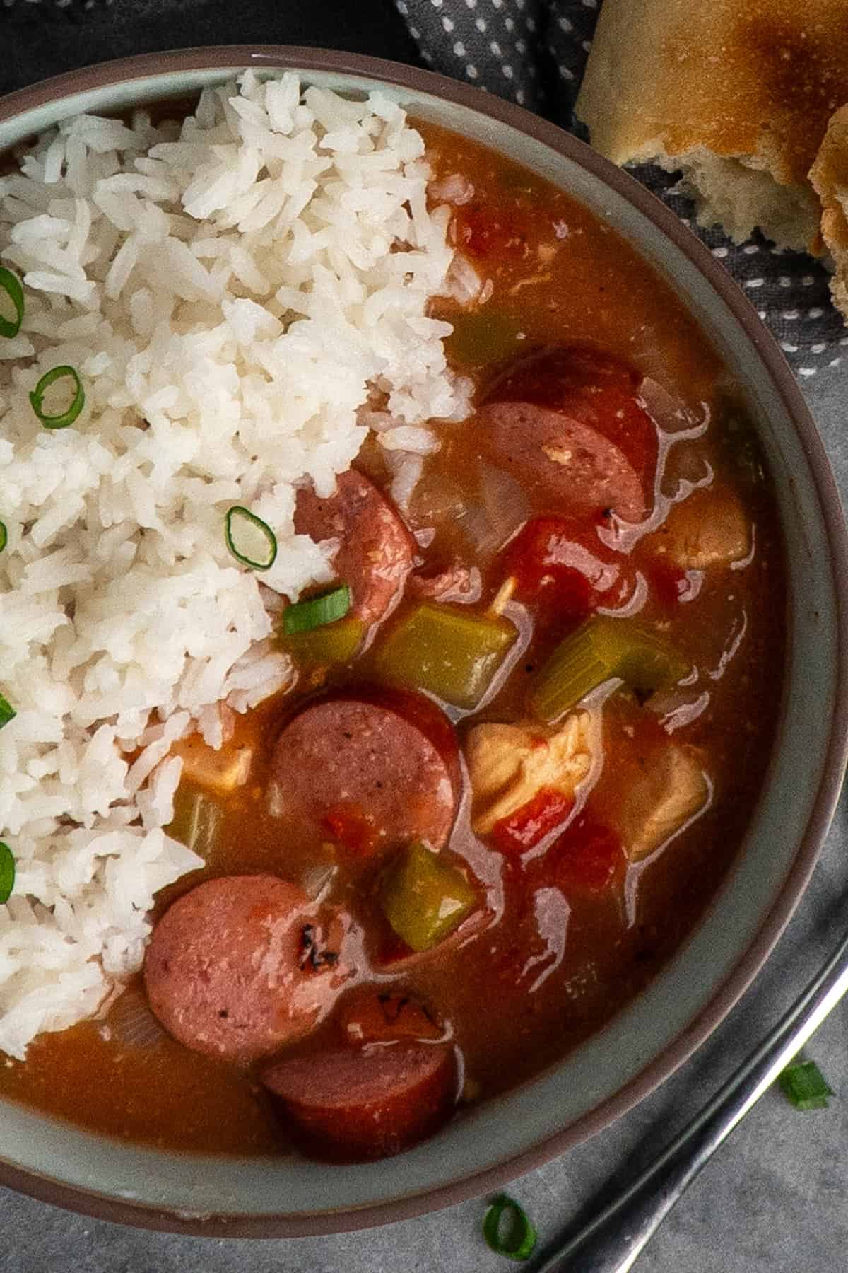 Slow cooker gumbo in a bowl with rice.