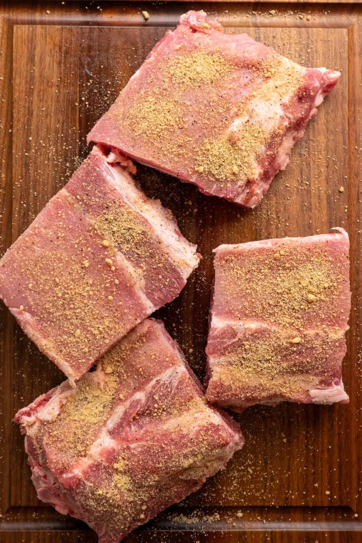 Ribs cut into four sections and rubbed with spice mixture.