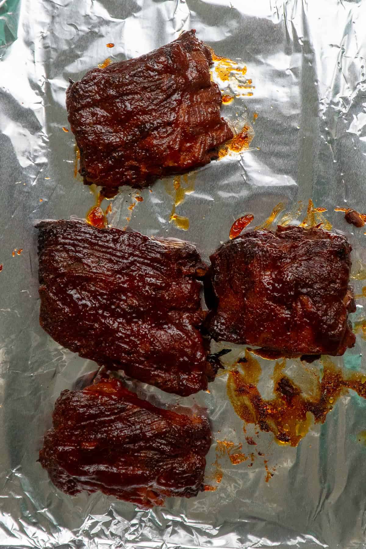 Slow cooker ribs on a foil lined baking sheet to broil.