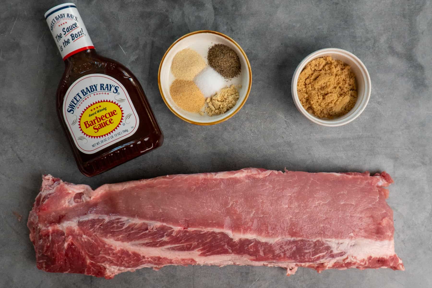 Ingredients to make slow cooker bbq rib sandwiches on the table before preparing.