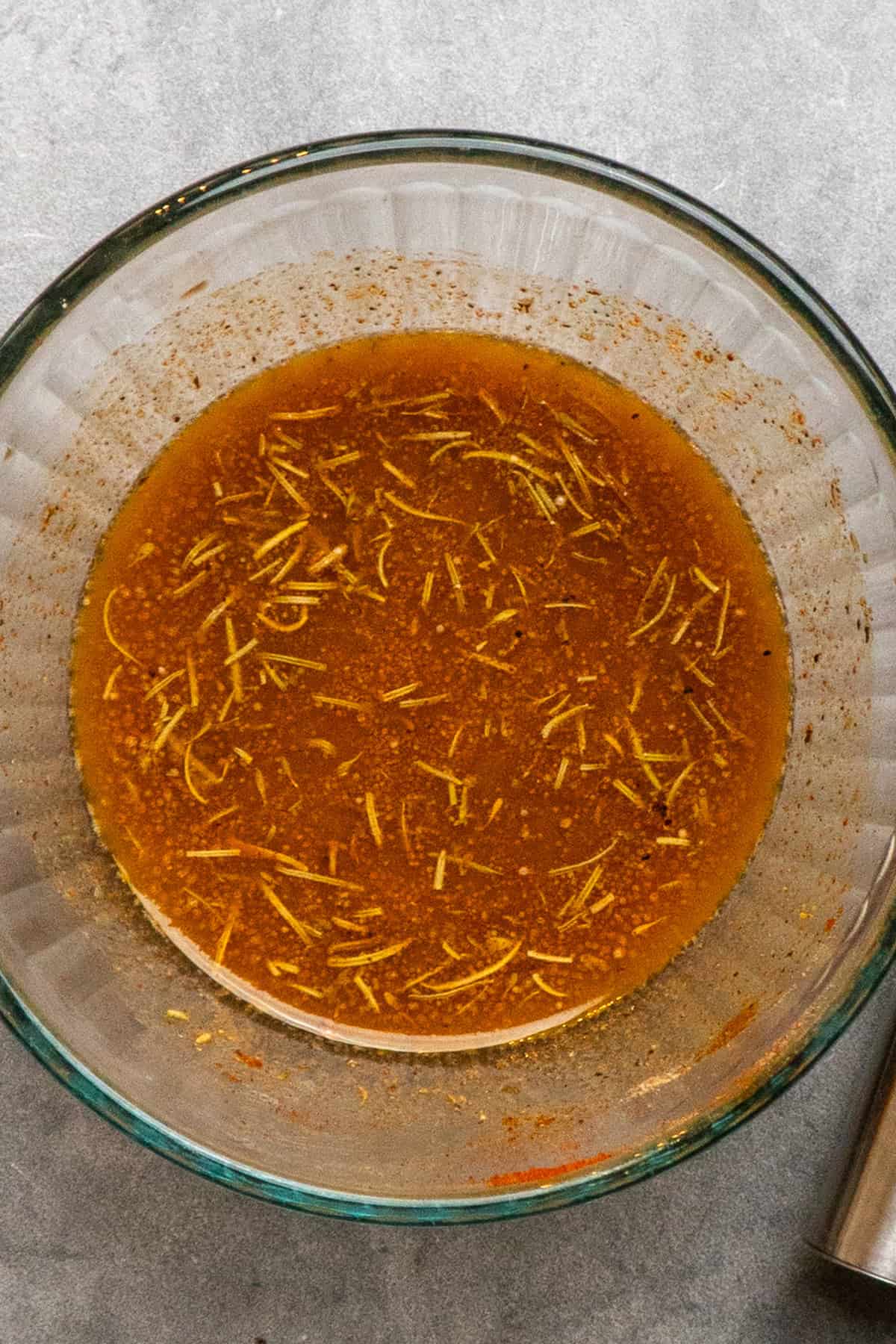 Melted butter, garlic, and seasonings mixed together in a bowl.