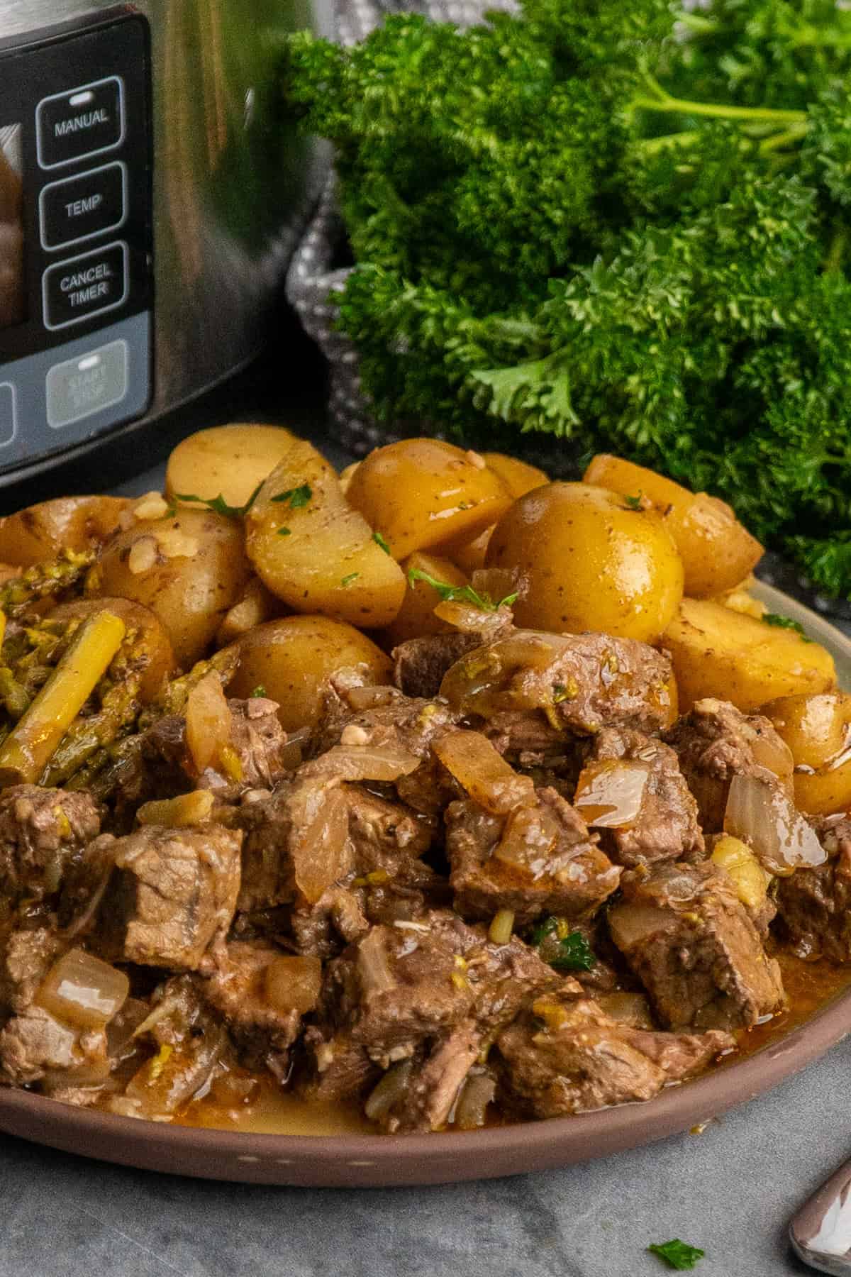 Crock Pot garlic butter steak bites on a plate ready to be eaten.