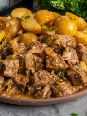 Crock Pot garlic butter steak bites on a plate ready to be eaten.