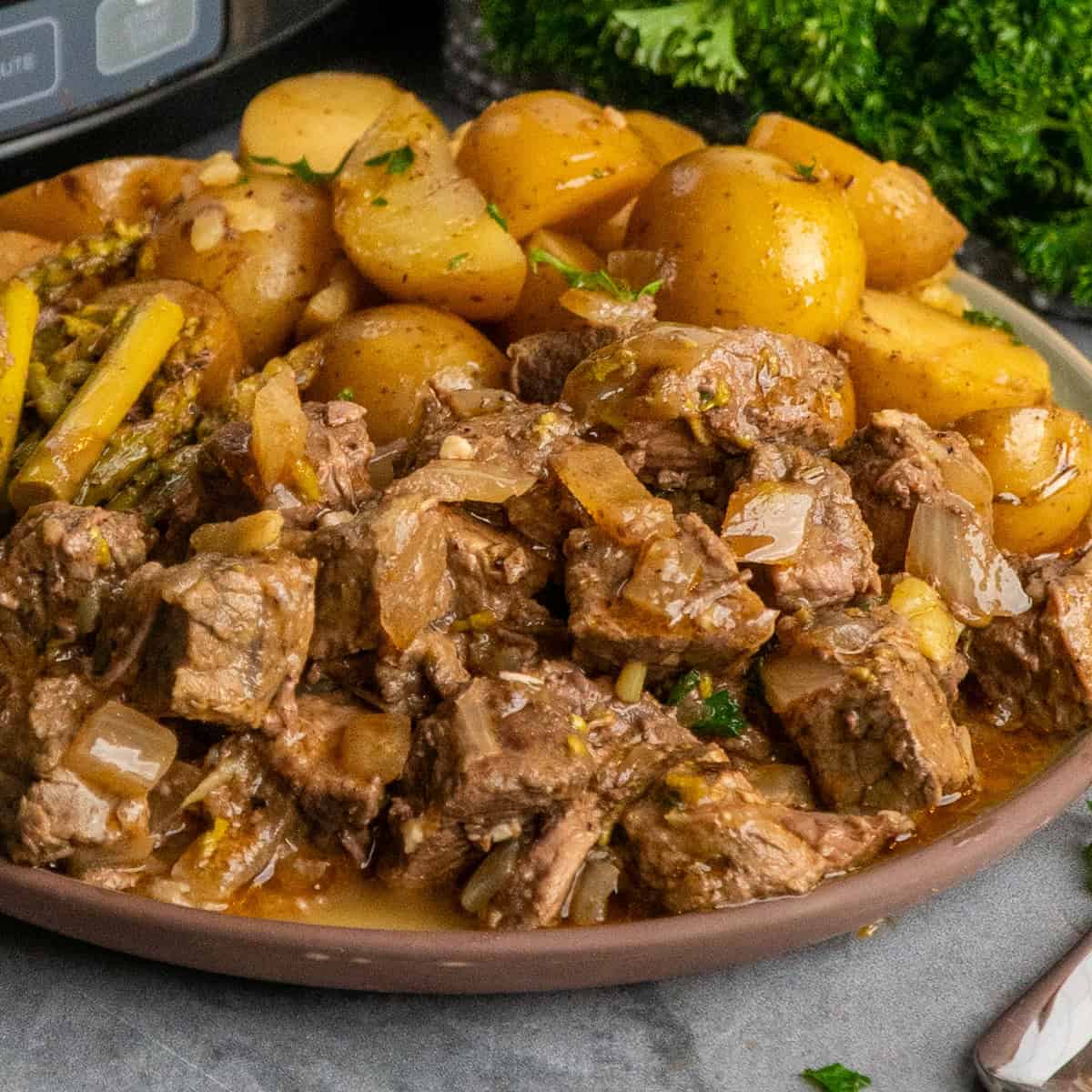 Crock Pot garlic butter steak bites on a plate ready to be eaten.