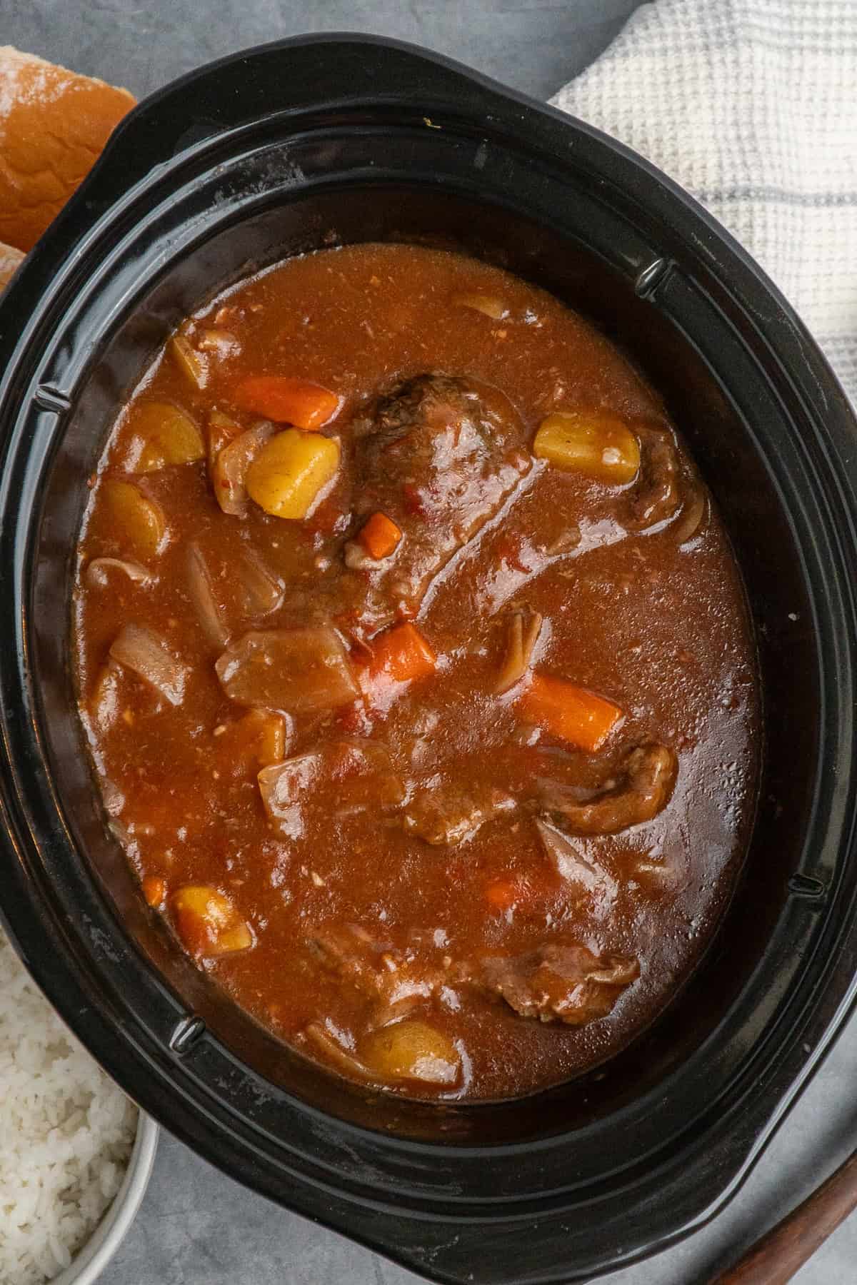 Swiss steak in a slow cooker when it's done cooking.