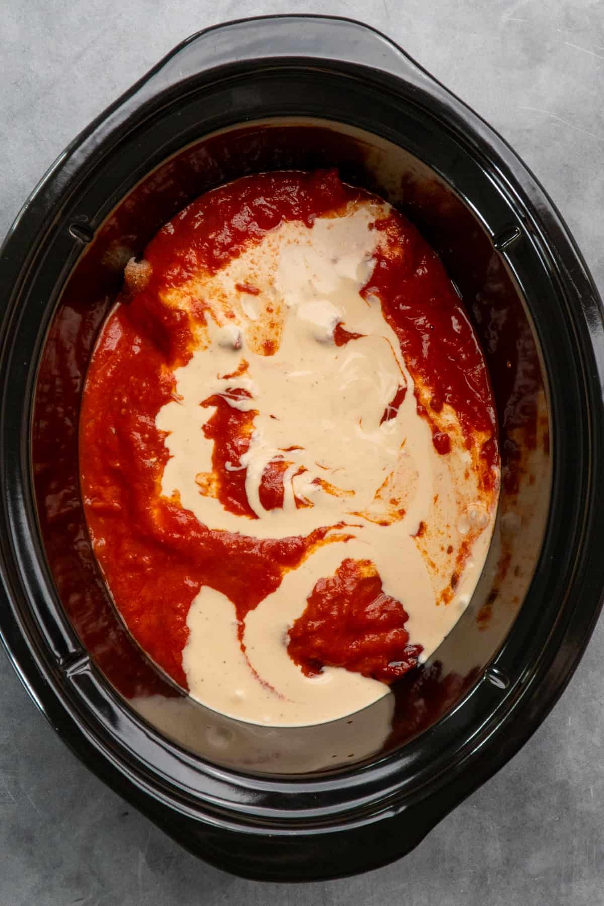 Marinara and alfredo sauce on top of chicken.