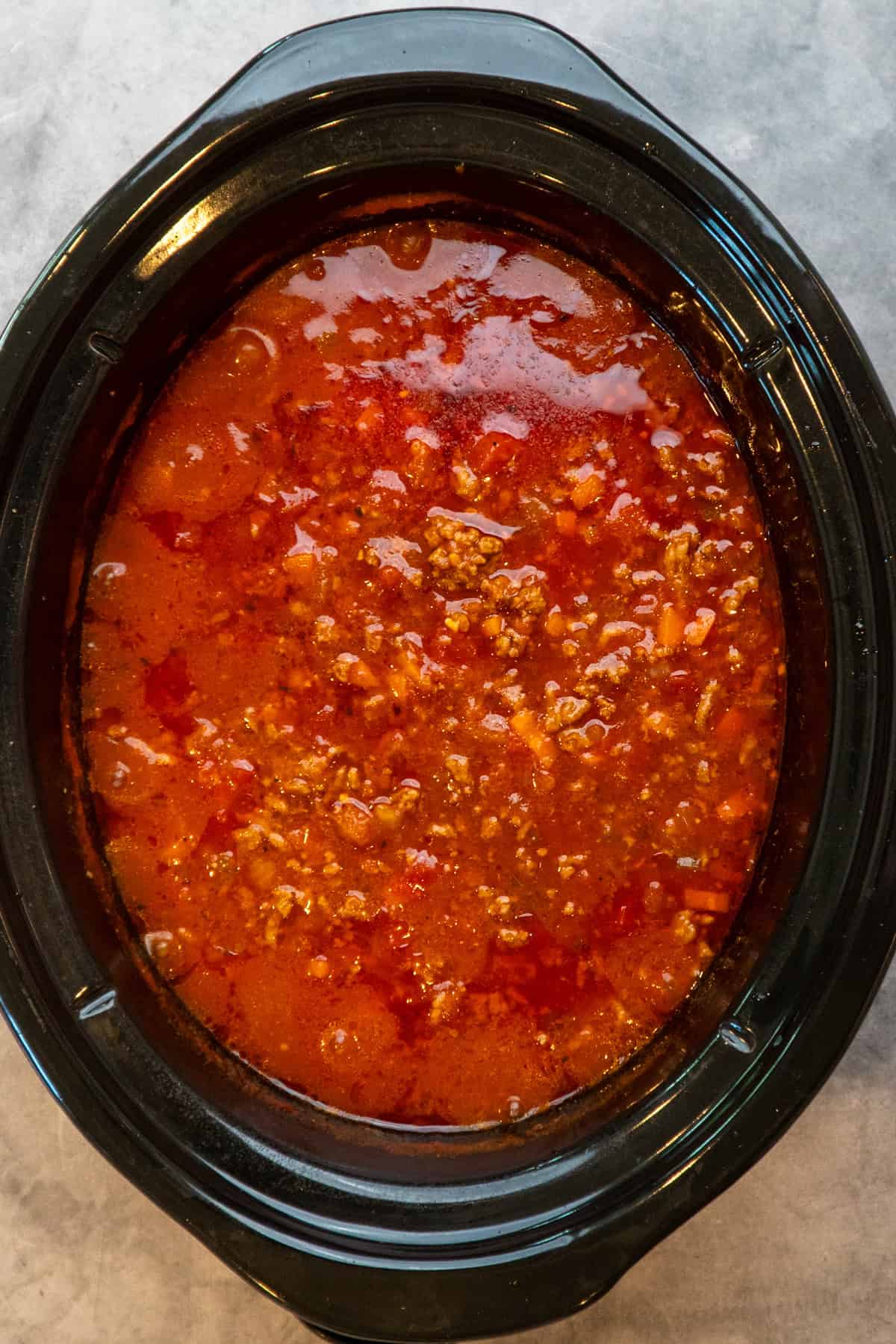 Simmered bolognese sauce in a slow cooker.