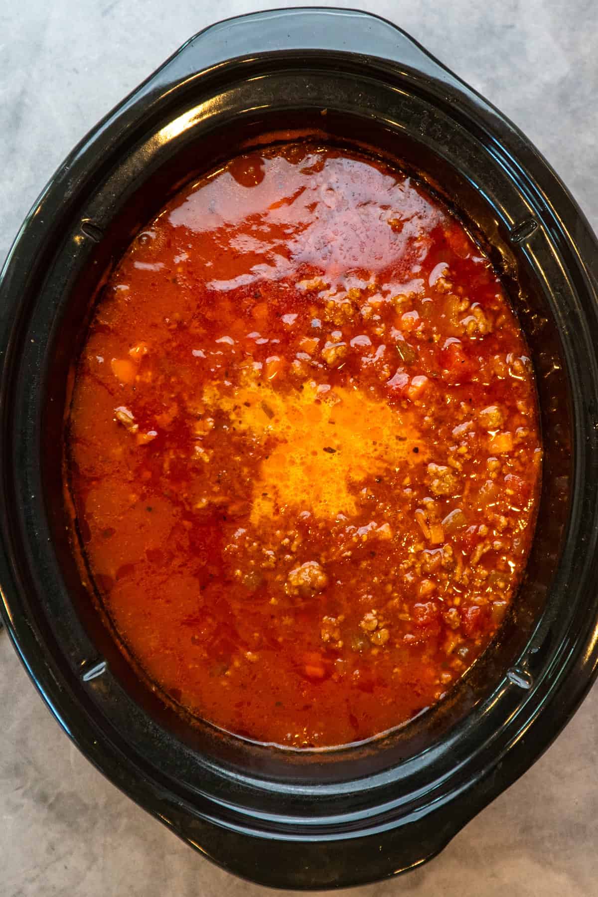 Milk add to the bolognese sauce in the slow cooker.