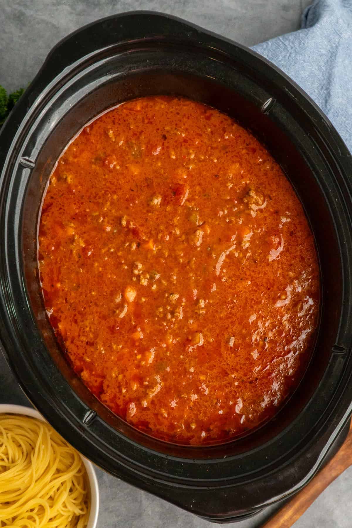 Cooked bolognese sauce in a slow cooker ready to be served.
