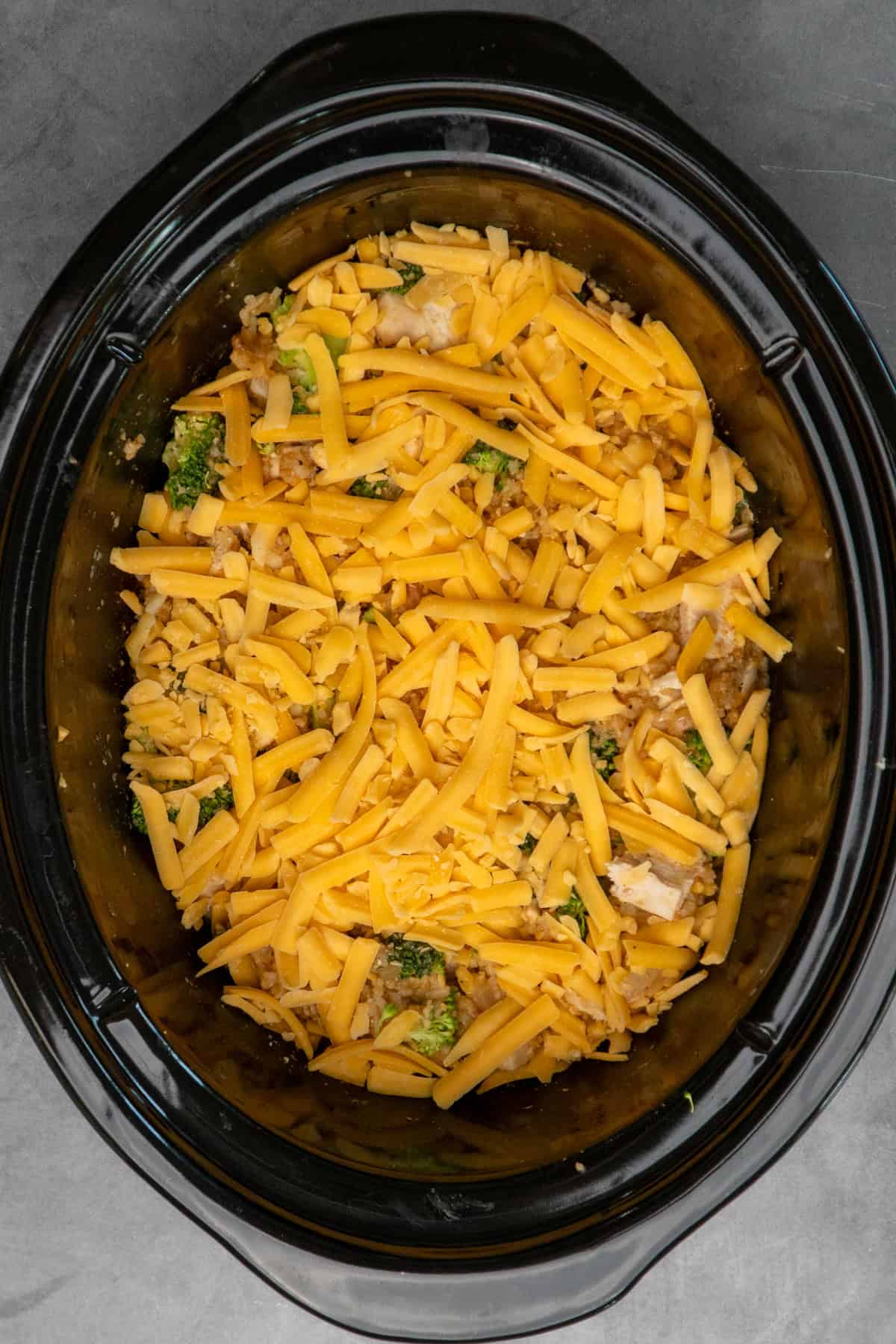Chopped chicken, broccoli and cheese added to crock pot.