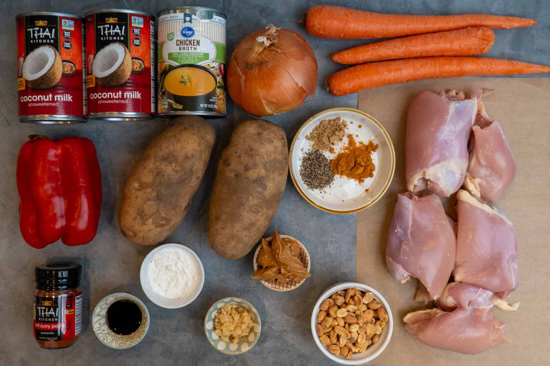Ingredients to make a slow cooker coconut chicken curry laid out on the counter before cooking.