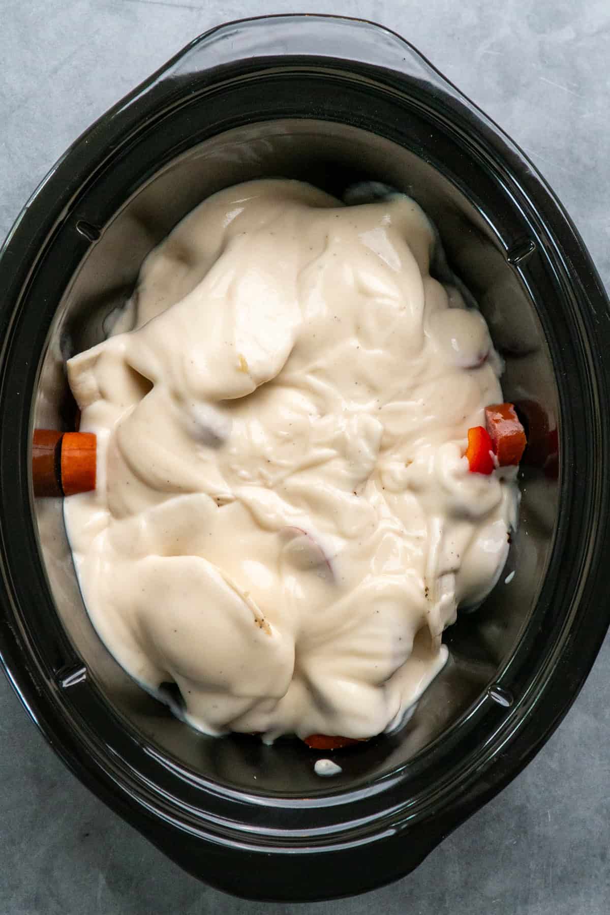 Alfredo sauce and spices mixed together and poured over the pierogie.