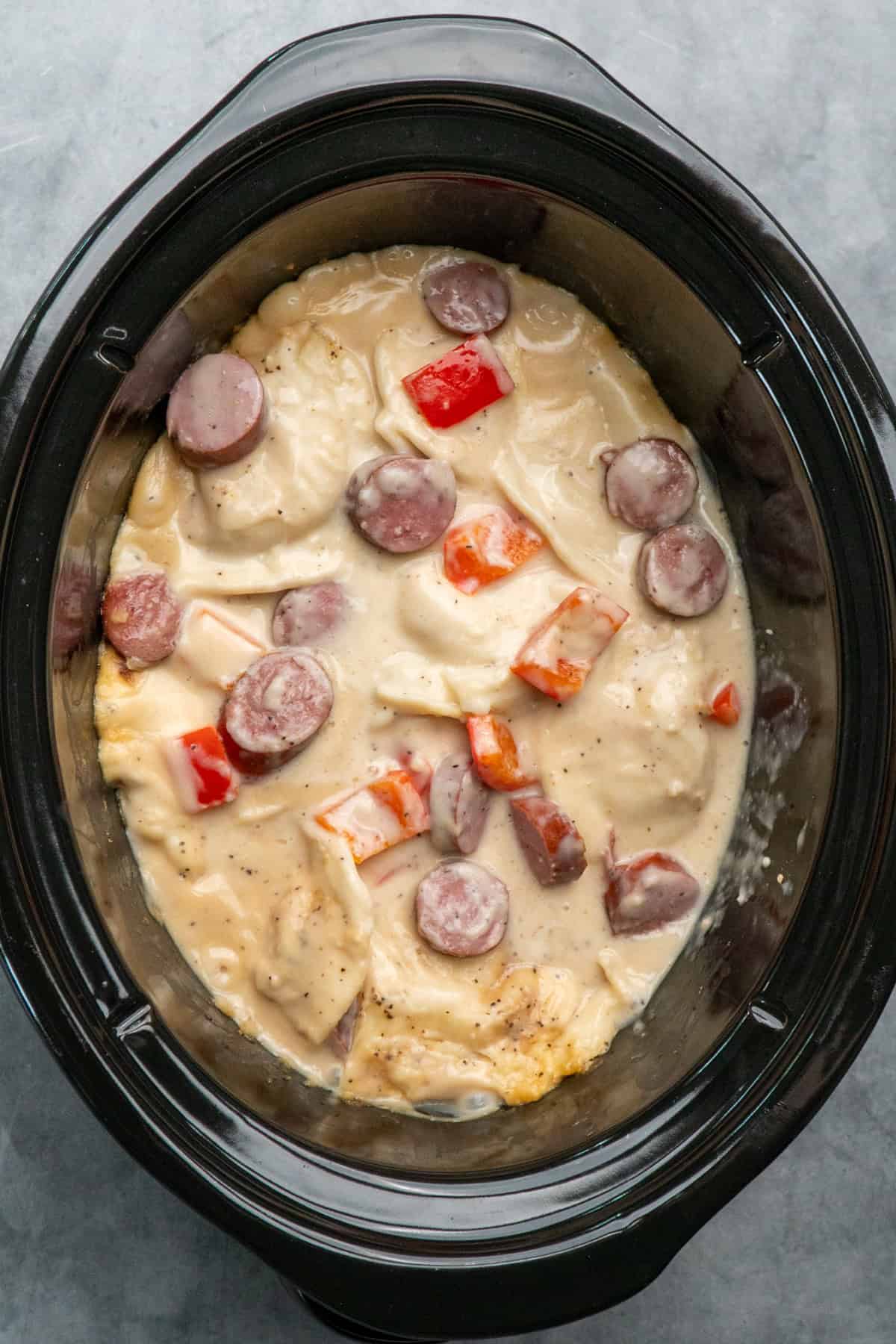 Cooked pierogi casserole that is ready for cheese.