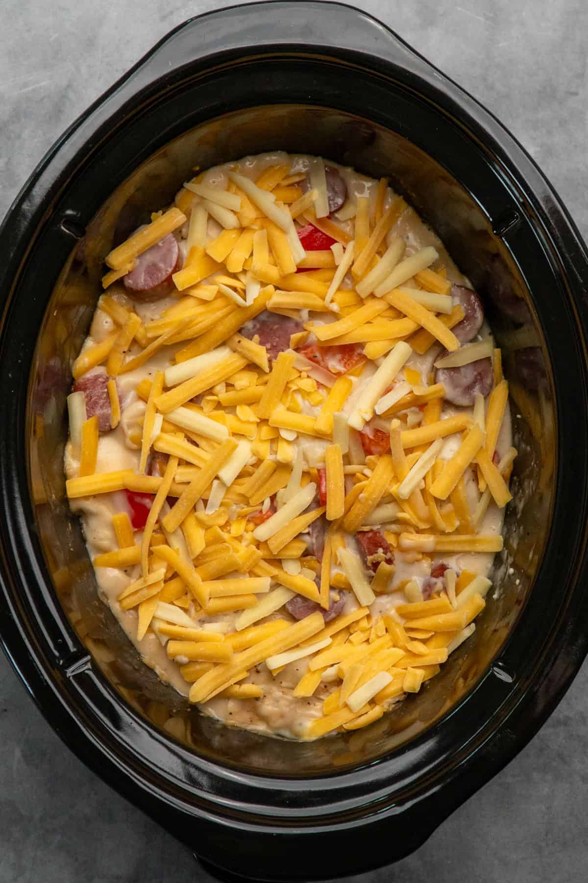 Cheese added to the pierogi casserole and ready to melt.
