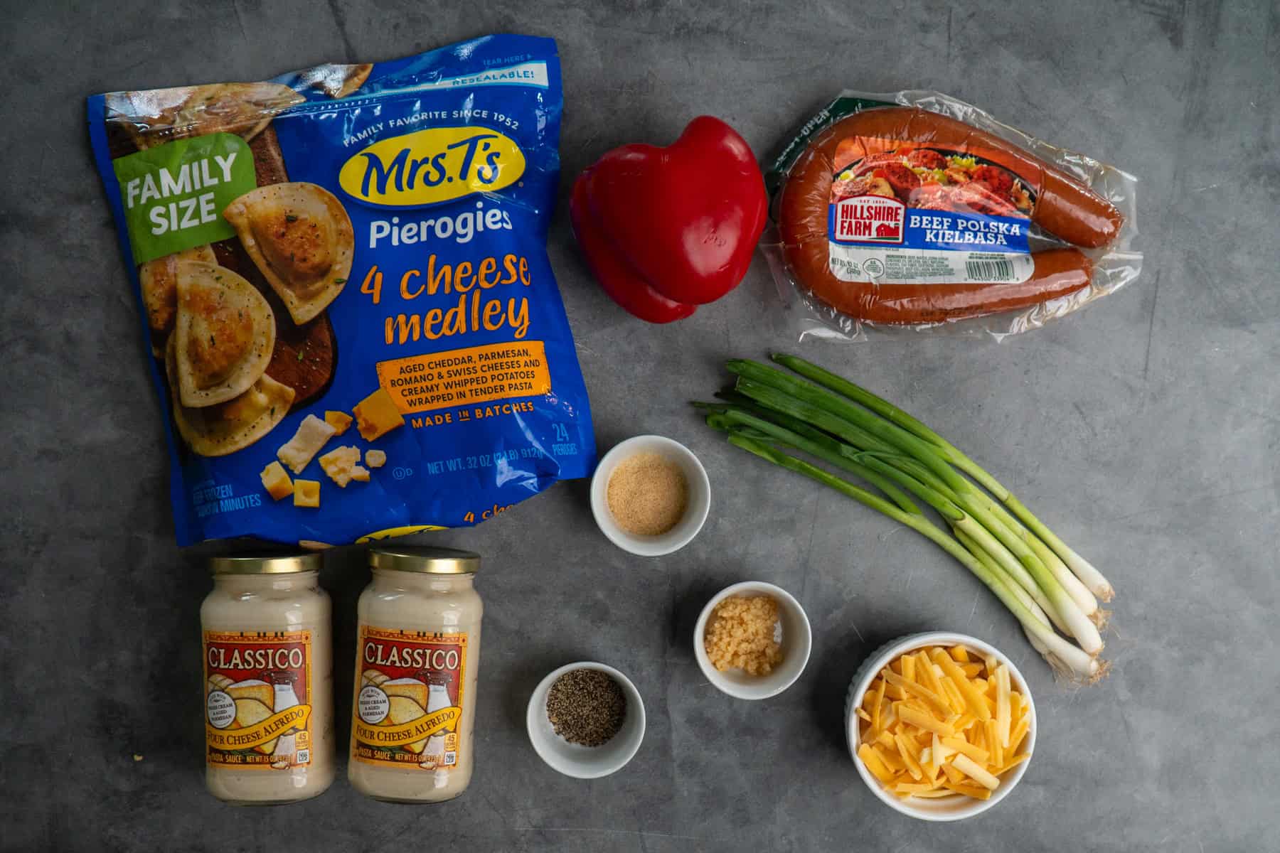 Ingredients to make pierogi casserole on a gray countertop.