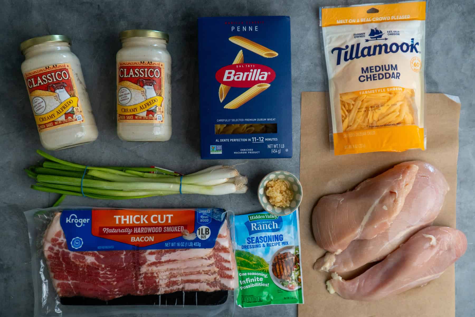 Ingredients to make crack chicken pasta on a gray countertop.