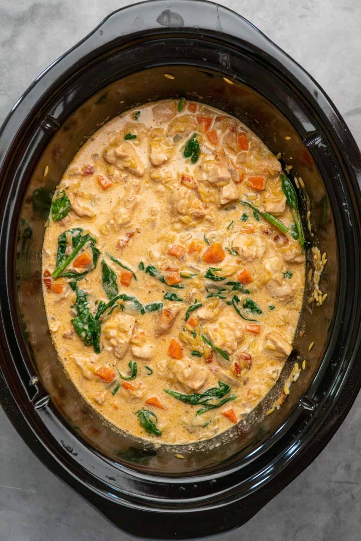 Mary me chicken orzo that has been cooked in a crock pot.