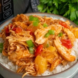 Crock pot pineapple BBQ chicken over a bowl of rice.