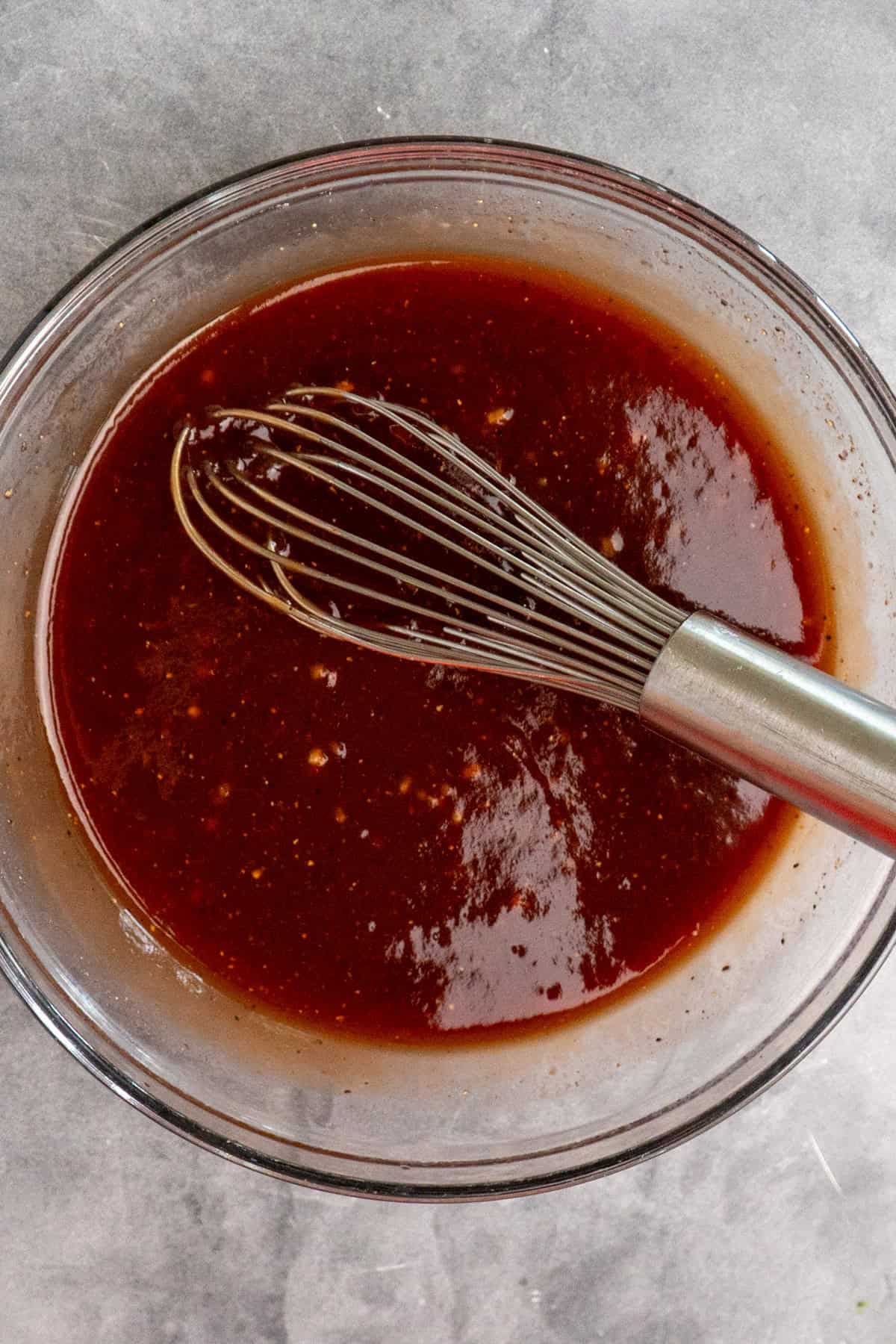 Pineapple BBQ sauce mixed together in a clear bowl.
