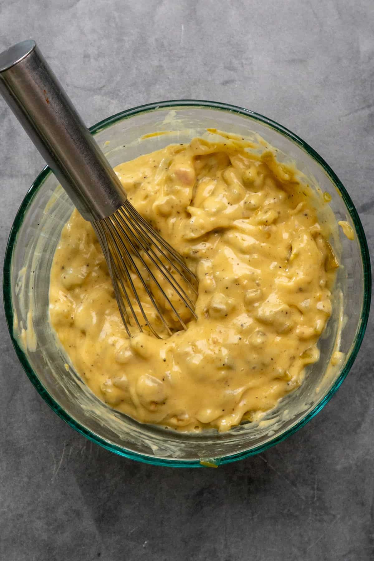 Green chile sauce mixed together in a clear bowl.