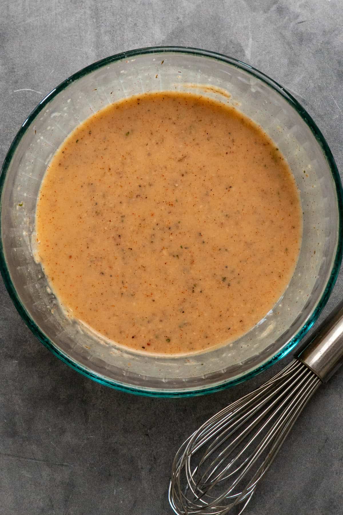 Sauce ingredients mixed together in a clear bowl.