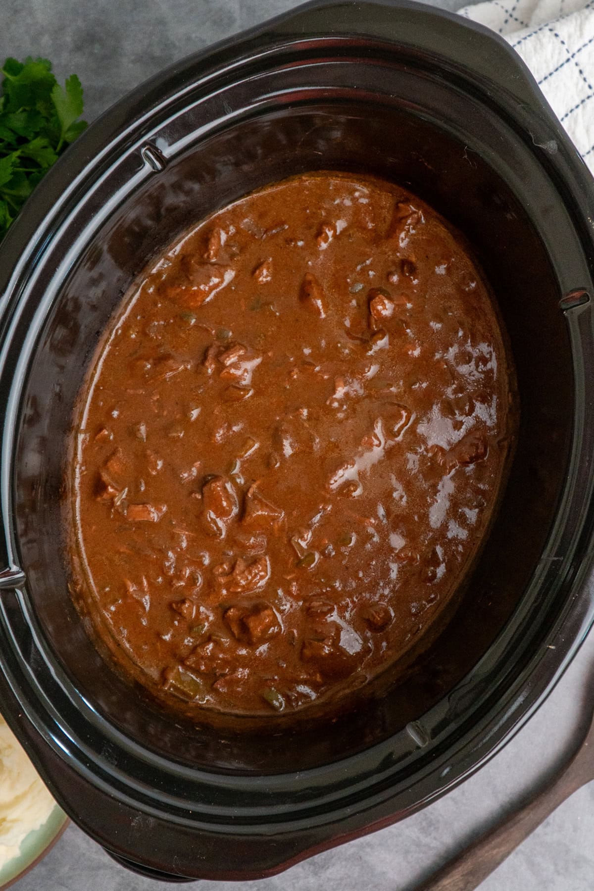 Steak and gravy that has been cooked and is ready to be served.