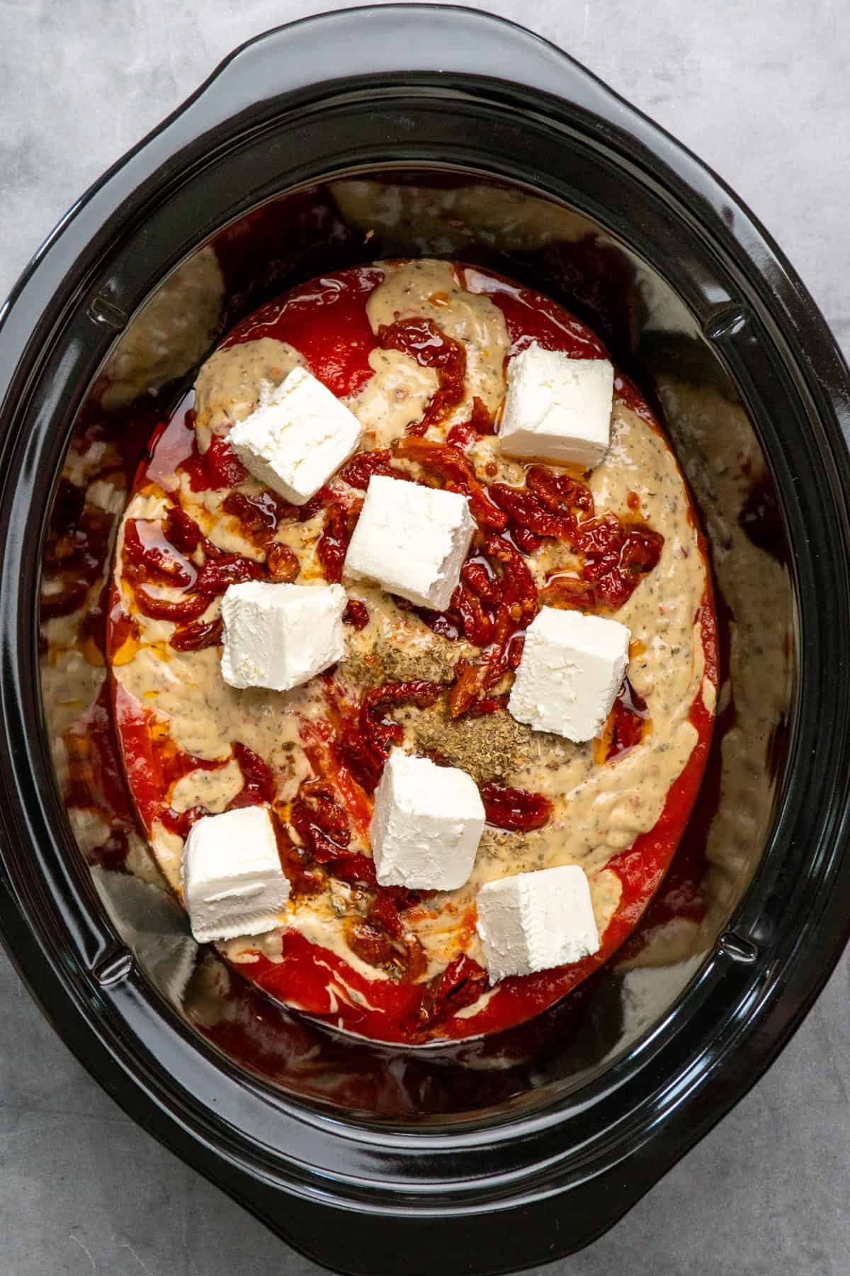 Sun-dried tomatoes, marinara sauce, and cream cheese on top of the chicken breast.