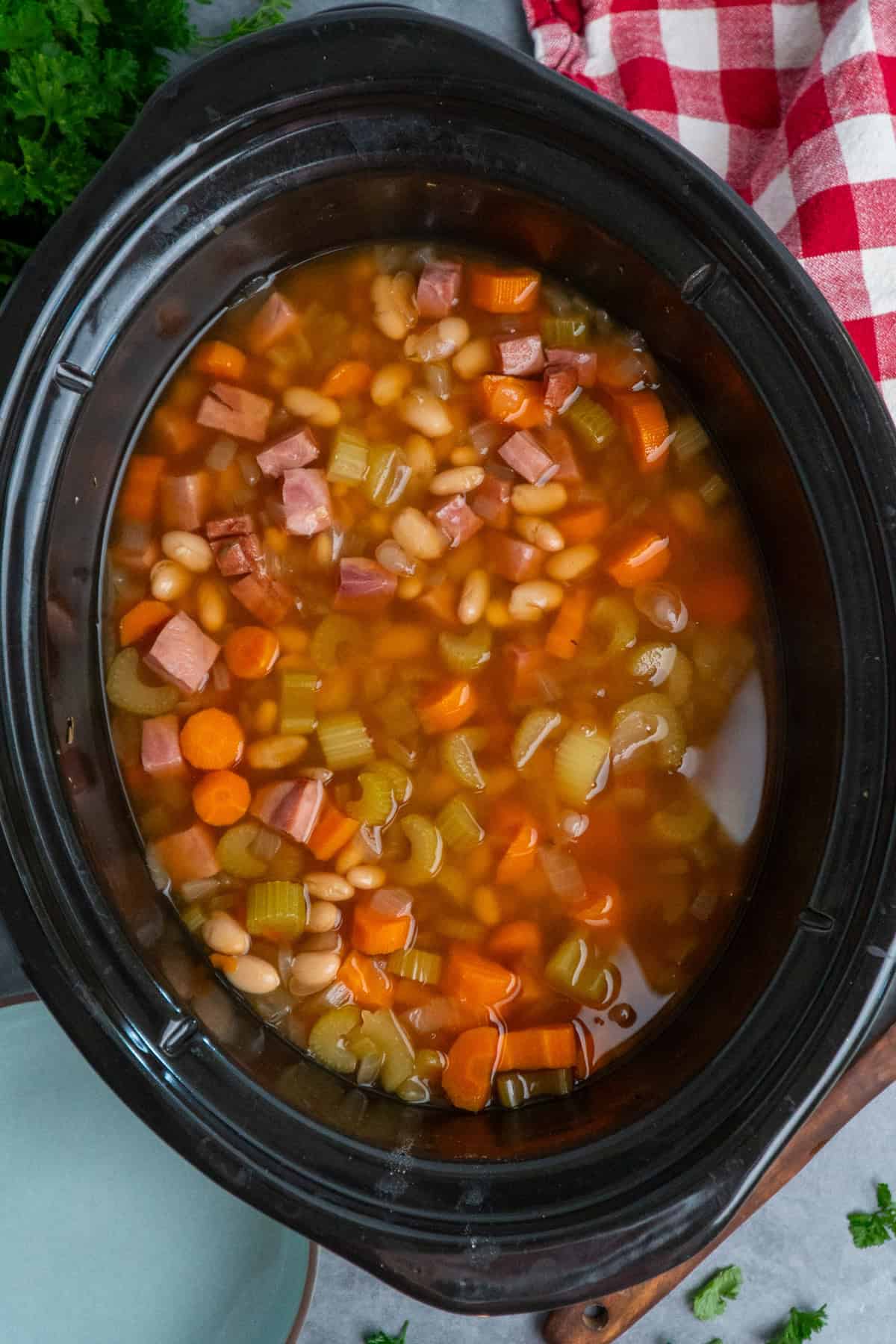 Slow cooker ham and bean soup with the bay leaves removed.