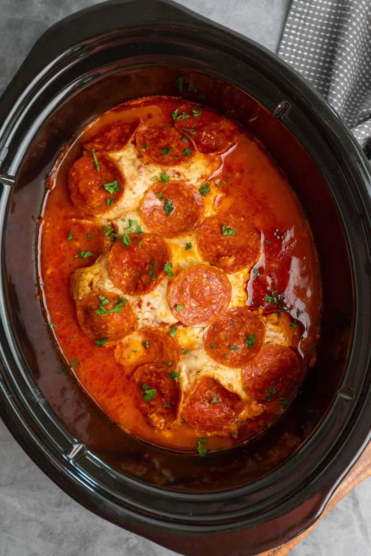 Pizza chicken that has been cooked in a slow cooker.