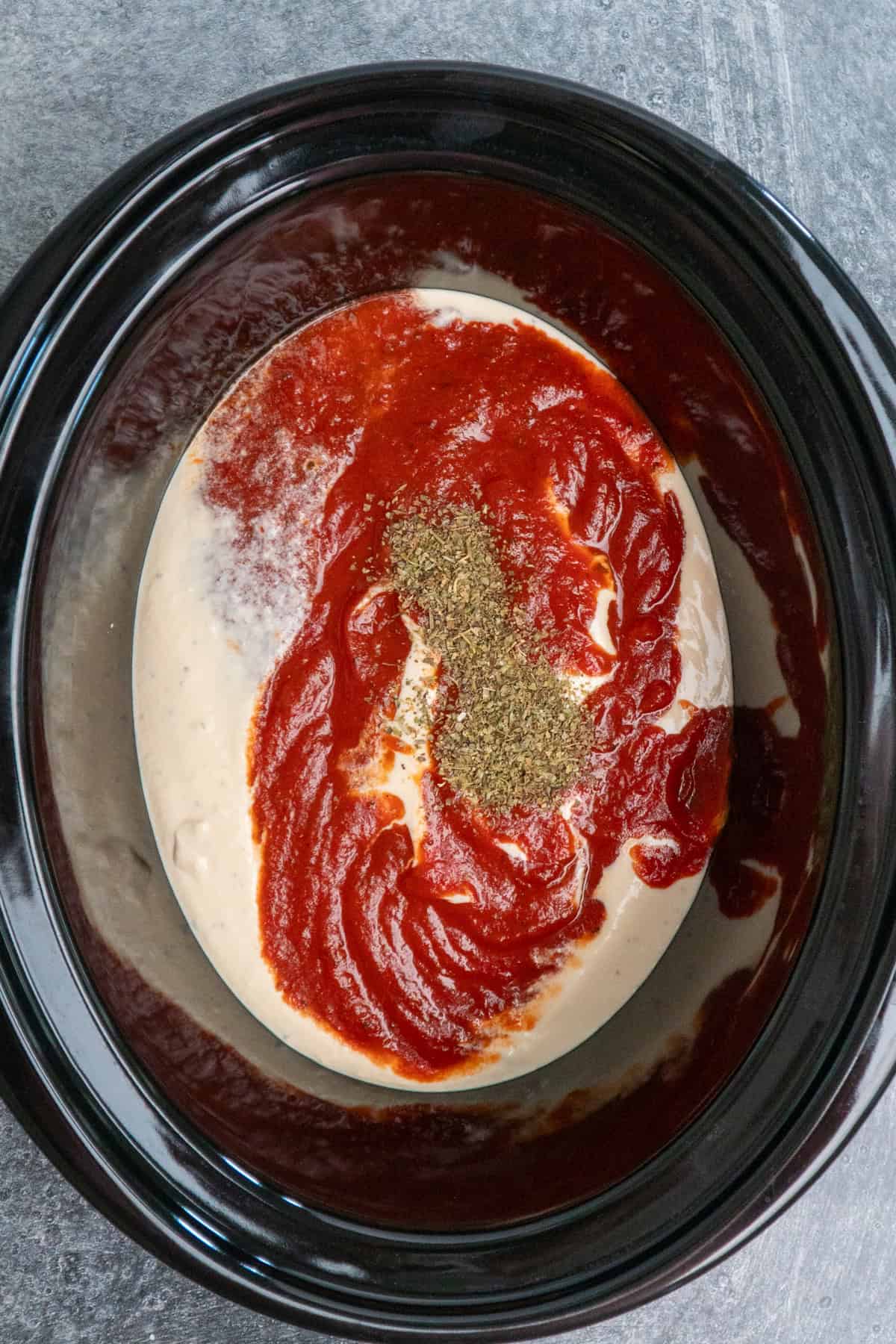 Italian seasoning, Alfredo sauce and marinara added to the crock pot.