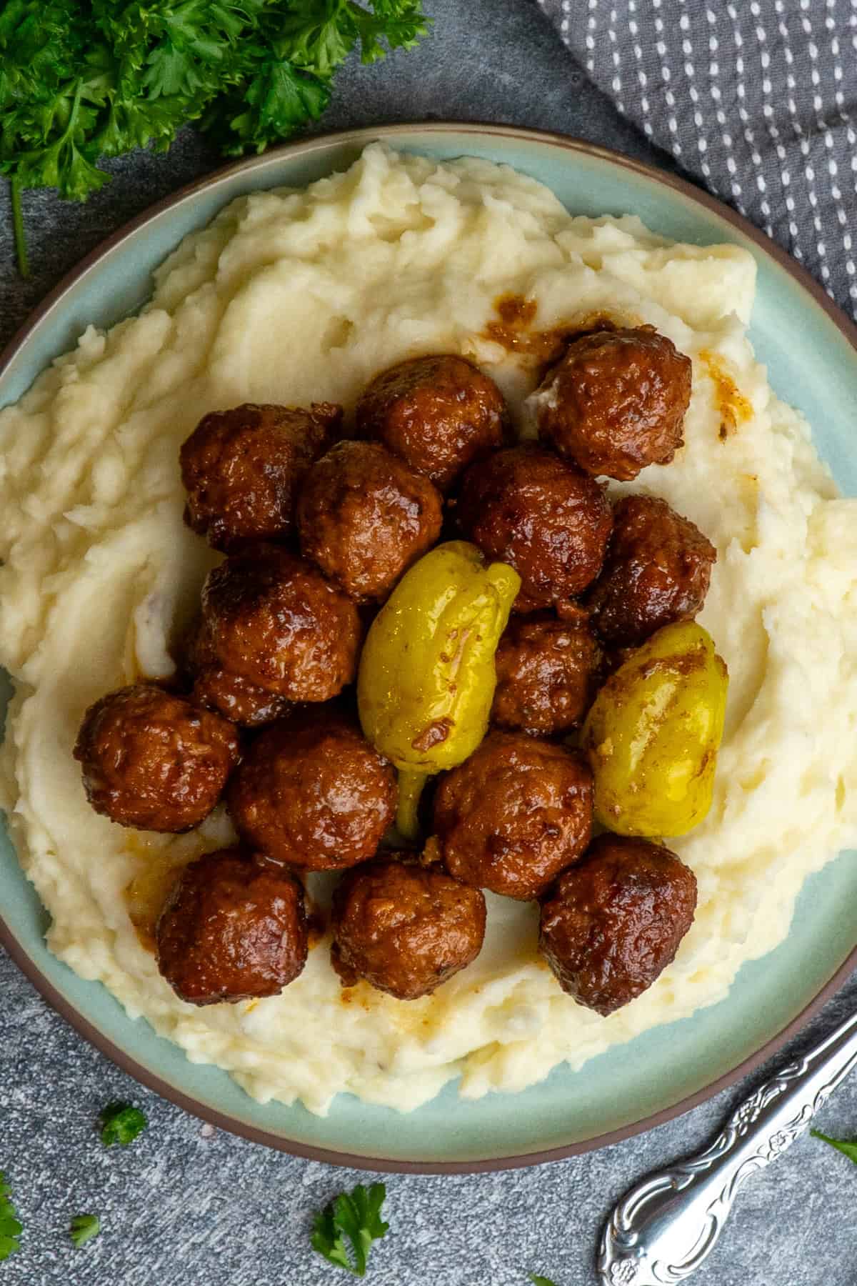 Mississippi meatballs over a plate of mashed potatoes.